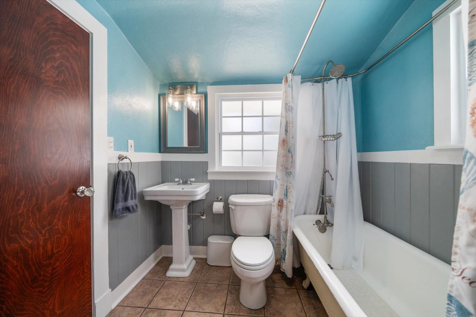 Primary bathroom with claw foot tub/shower and pedestal vanity