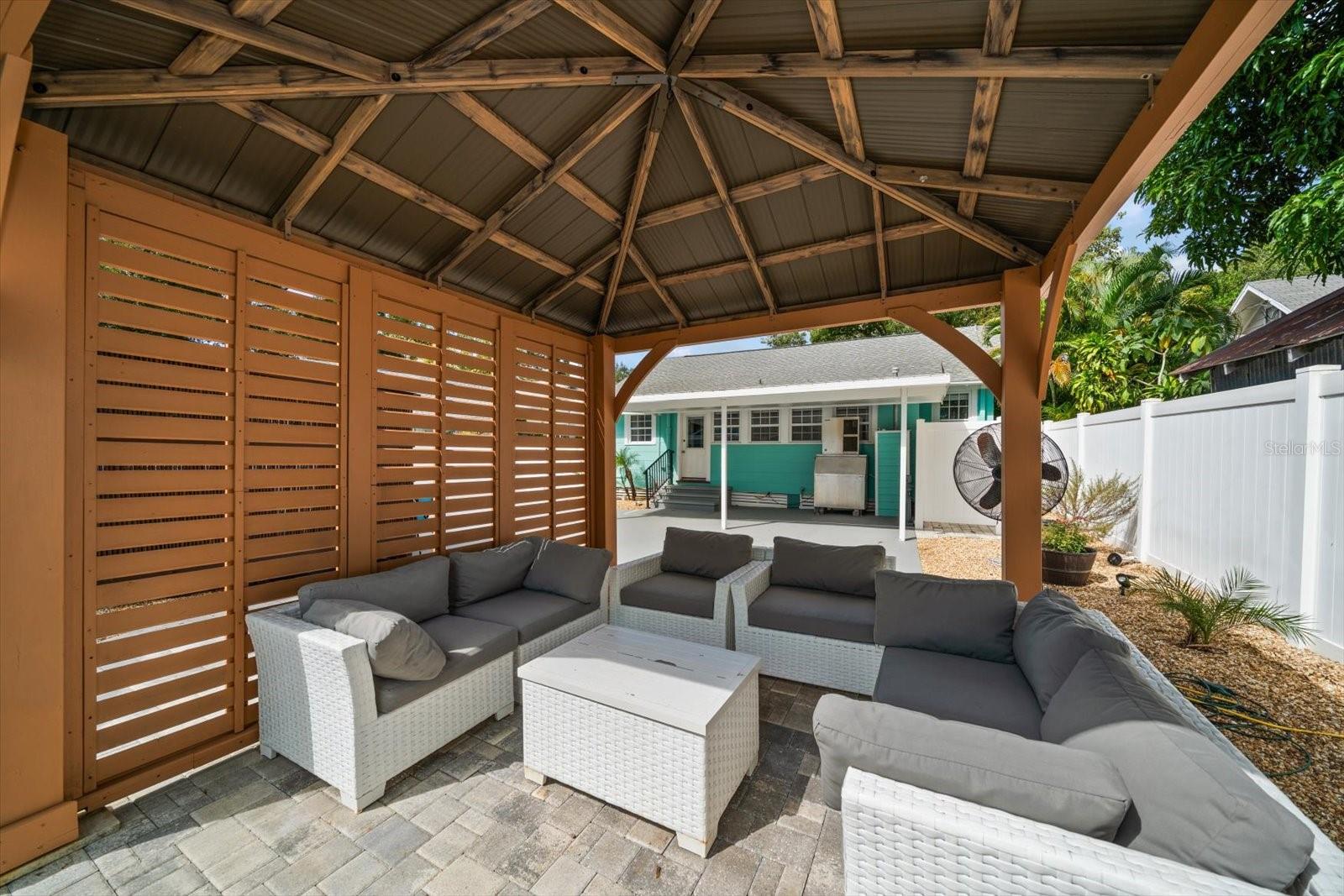 Gazebo with outdoor seating area overlooking the pool