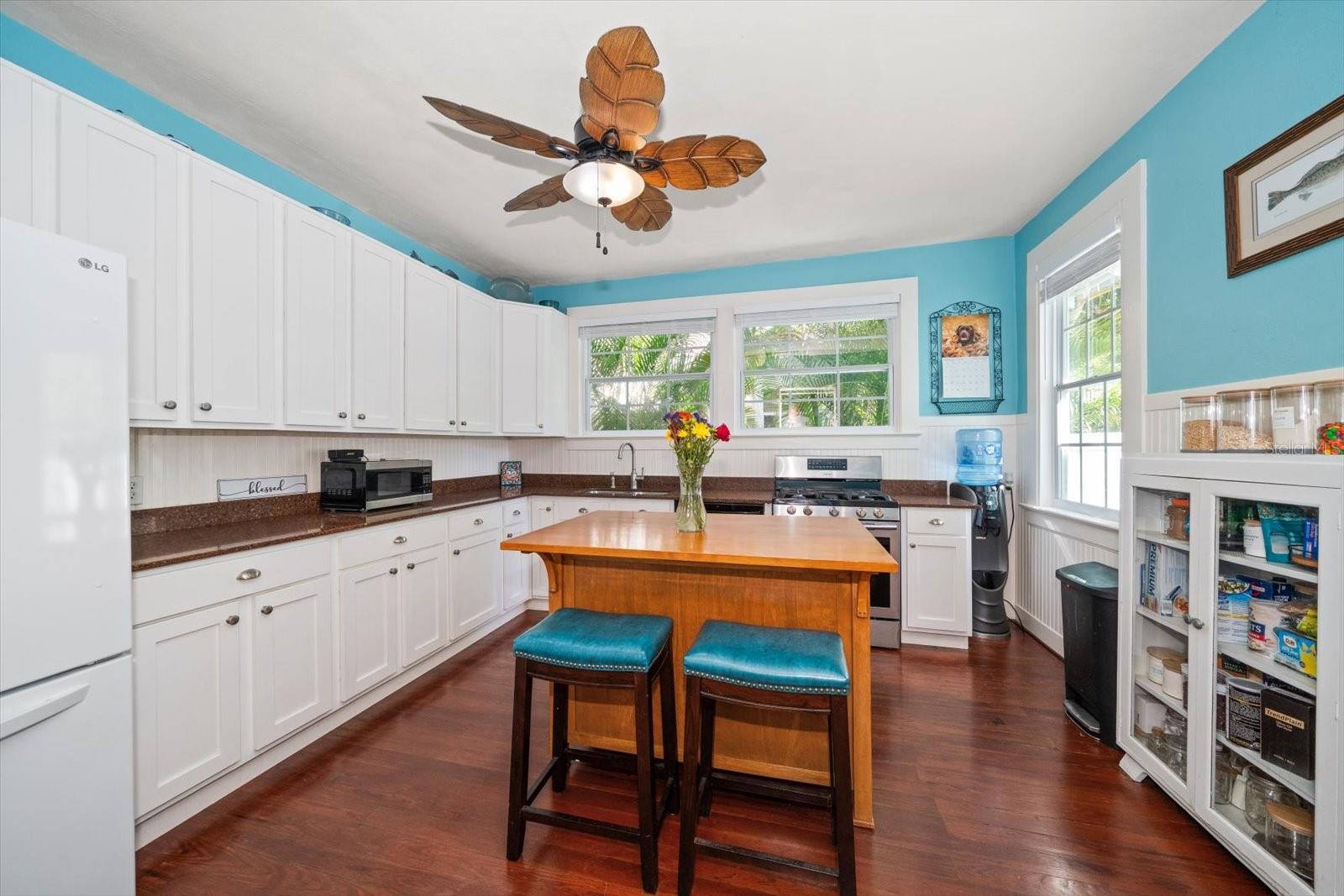 Updated kitchen with wood cabinets and granite counters