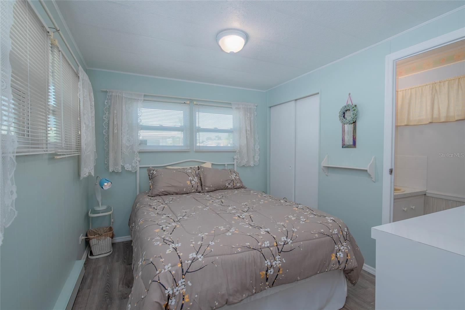 Primary bedroom furnished with ensuite half bathroom.