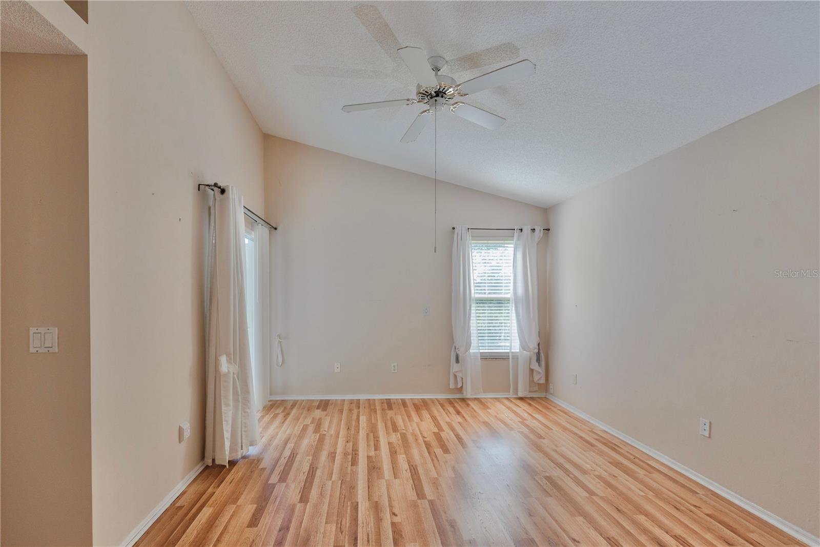 Primary bedroom with vaulted ceilings.