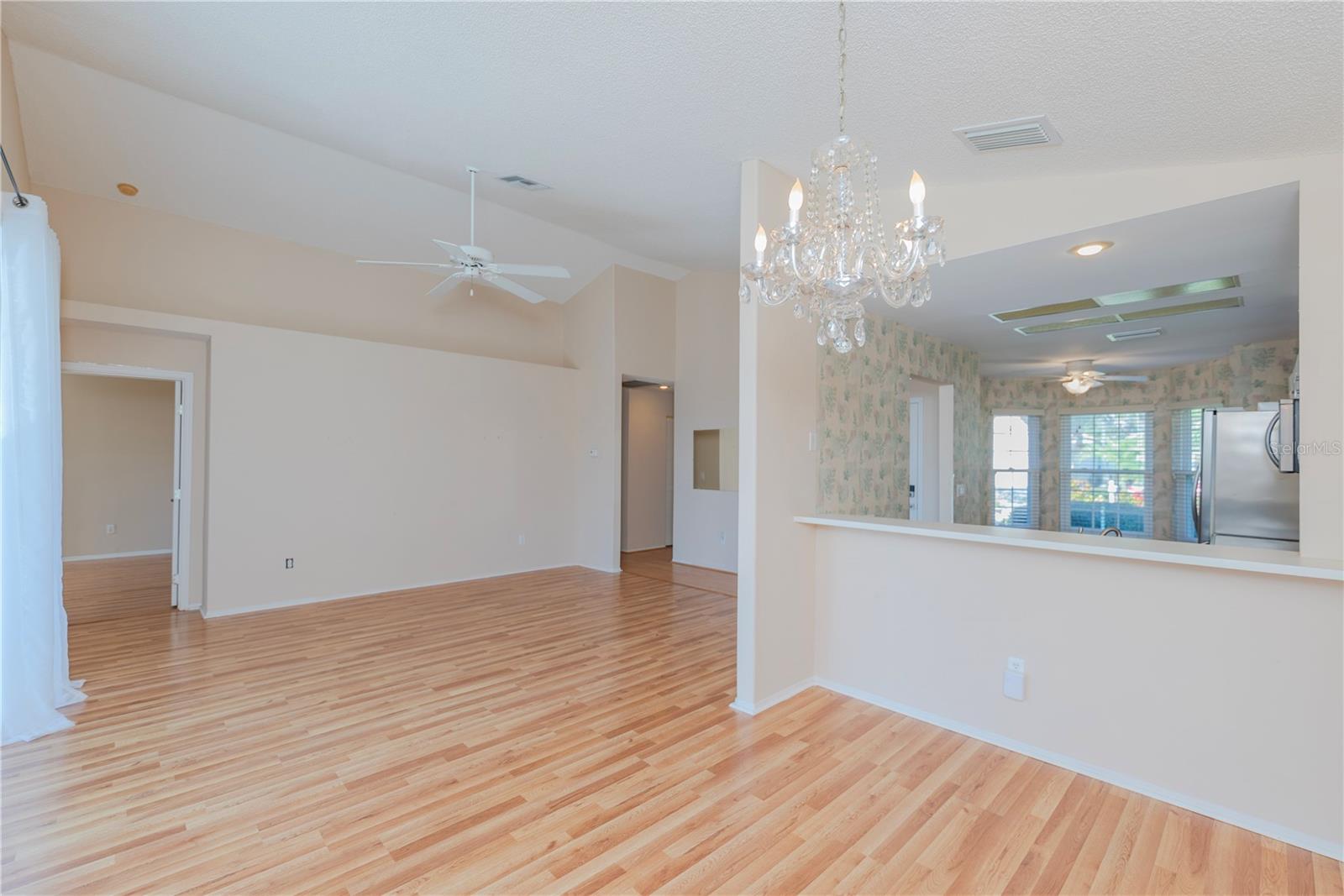Dining room with view of living room and pass through to kitchen.