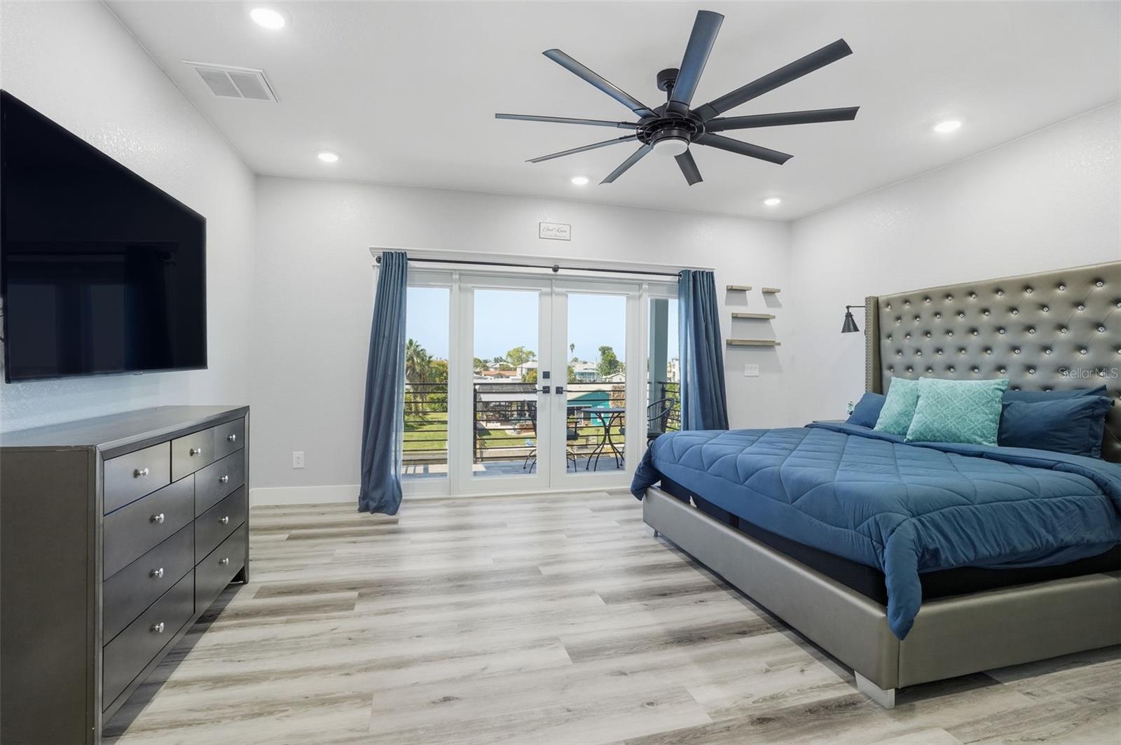 Master bedroom with private balcony overlooking the water and pool...facing the sunset!
