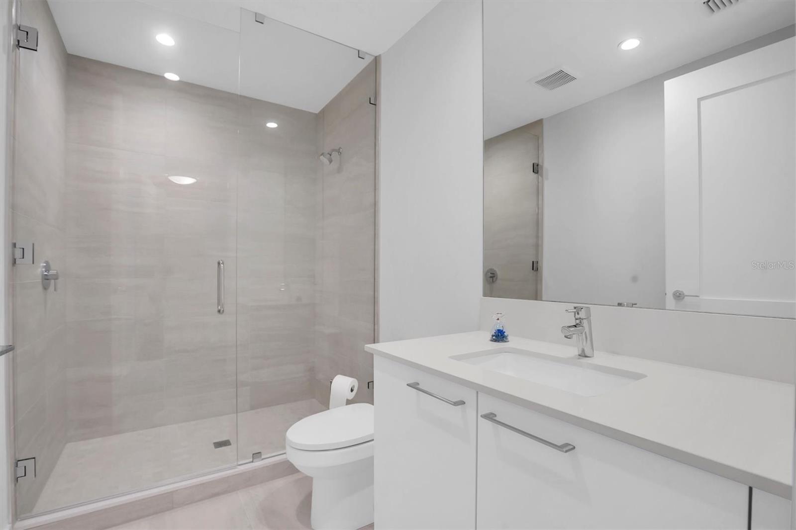The third bedroom features a private ensuite bath with a spacious shower
