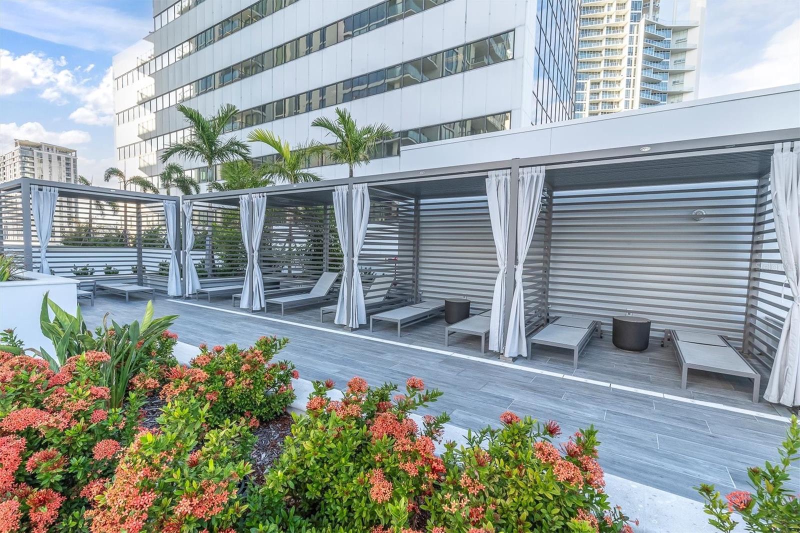 Relax in comfort with shaded poolside cabanas, perfect for lounging and socializing