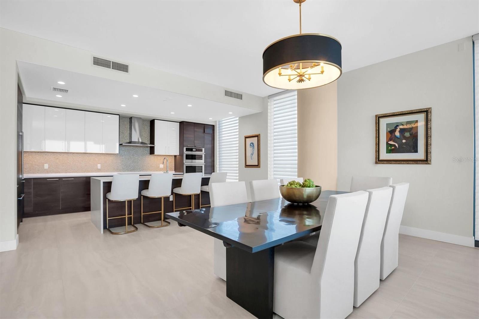 Elegant and spacious dining room highlighted by a custom chandelier