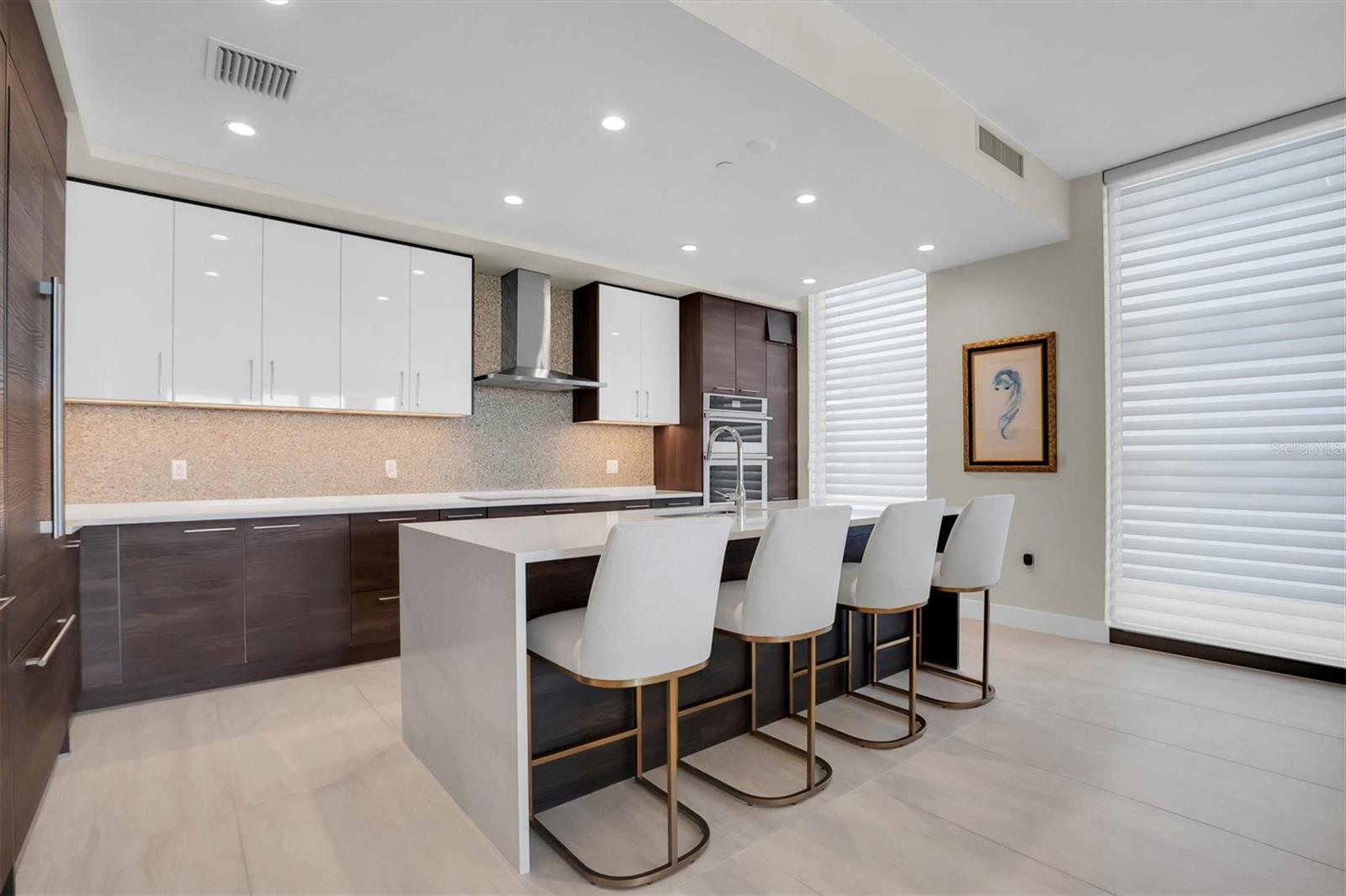 Chef’s kitchen featuring a stunning quartz center island, perfect for cooking, dining, and entertaining