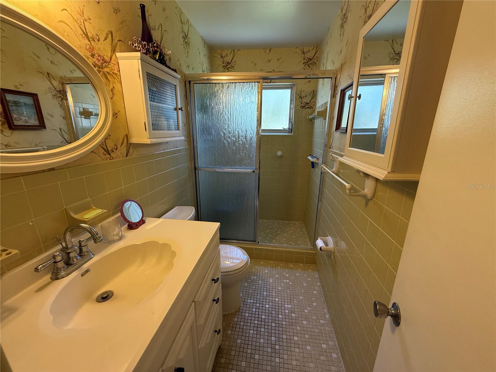 Primary bathroom with wlak-in shower and glass slider door
