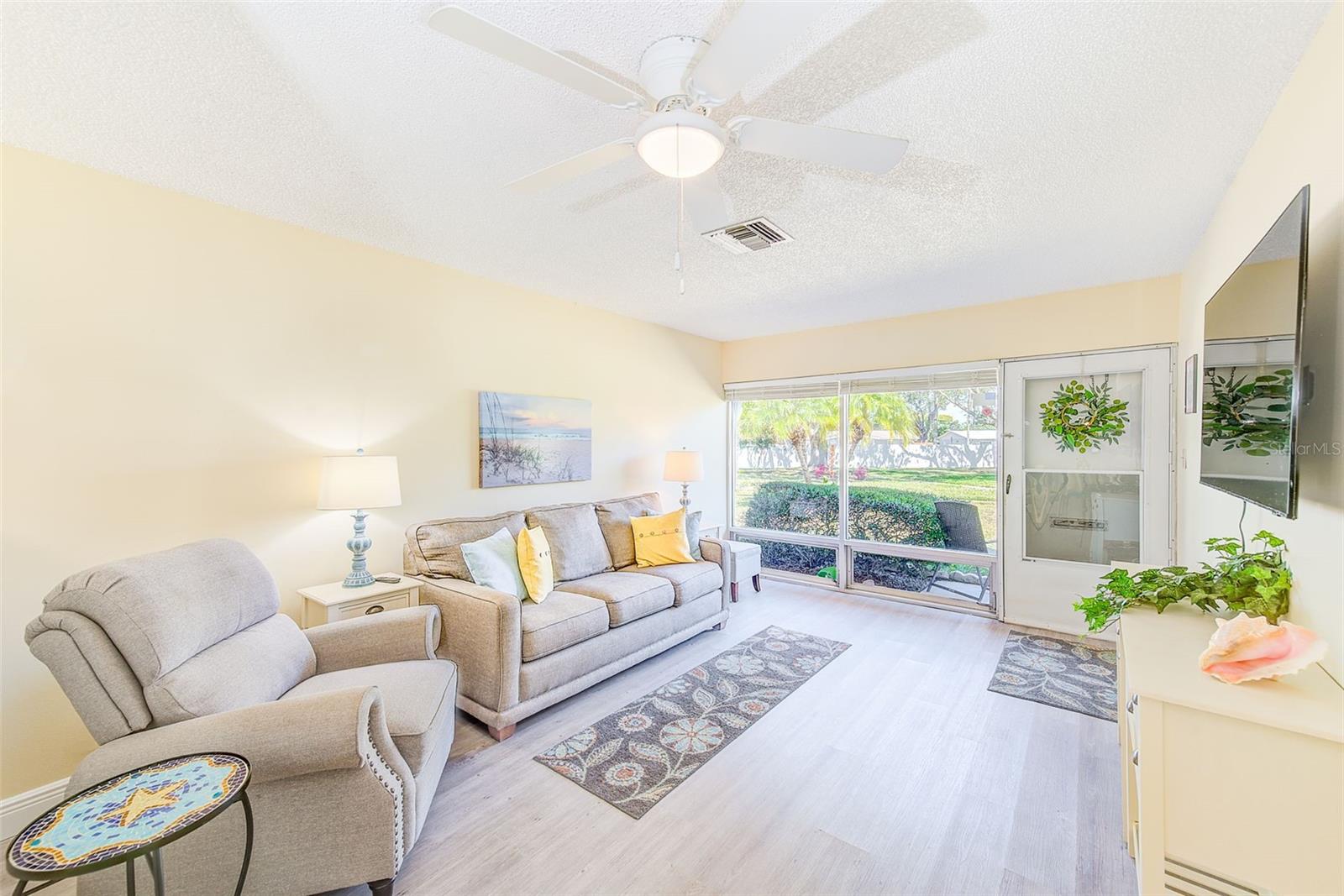 Living room with bright windows and vinyl Plank flooring
