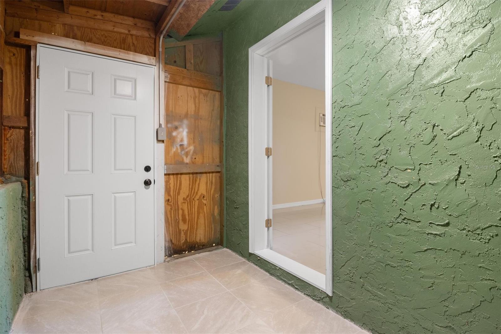 Storage Room/Separate Entrance into 1st Floor Primary Suite
