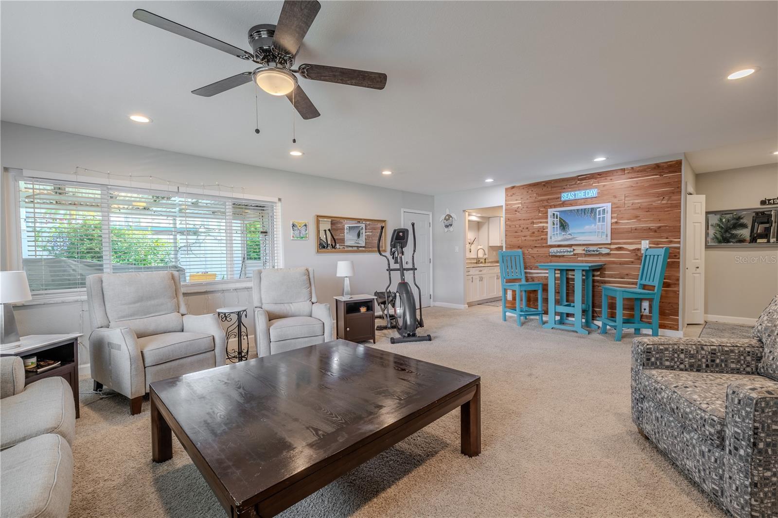 From this angle, the living area flows seamlessly into the extended bonus room, emphasizing how the design invites both relaxation and versatility in daily living.