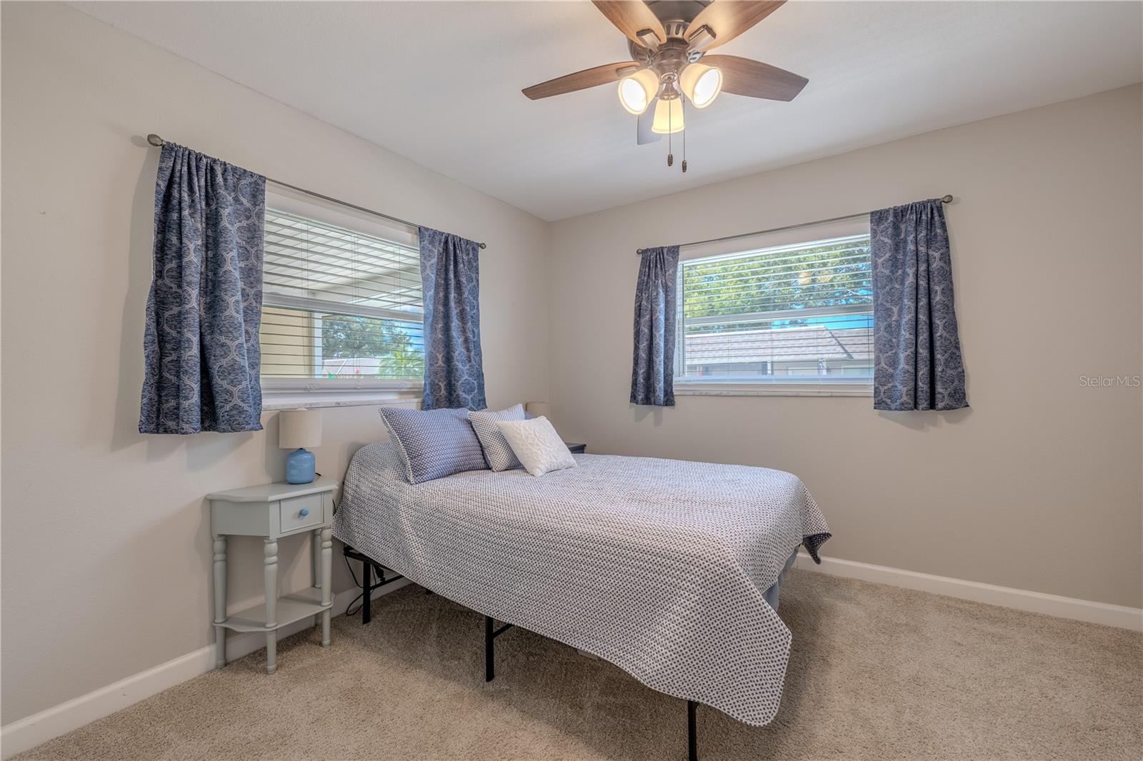 Inviting guest bedroom filled with natural light and a calm, neutral palette. The space feels open yet cozy, ideal for family visits or a peaceful reading retreat.