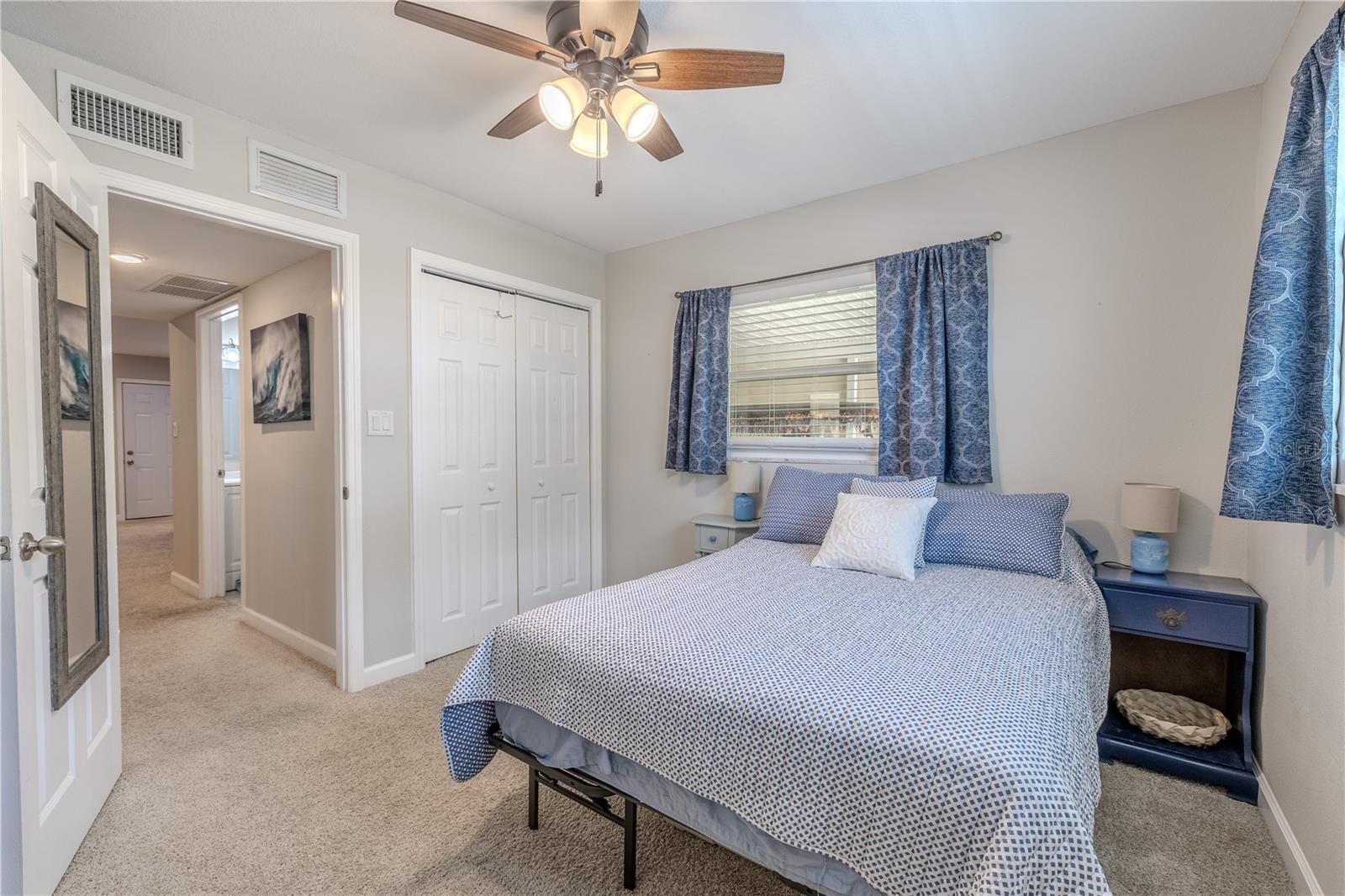 Another angle highlighting the room’s comfortable proportions and soft carpeting. Its central location near the hall bath makes it both functional and private.