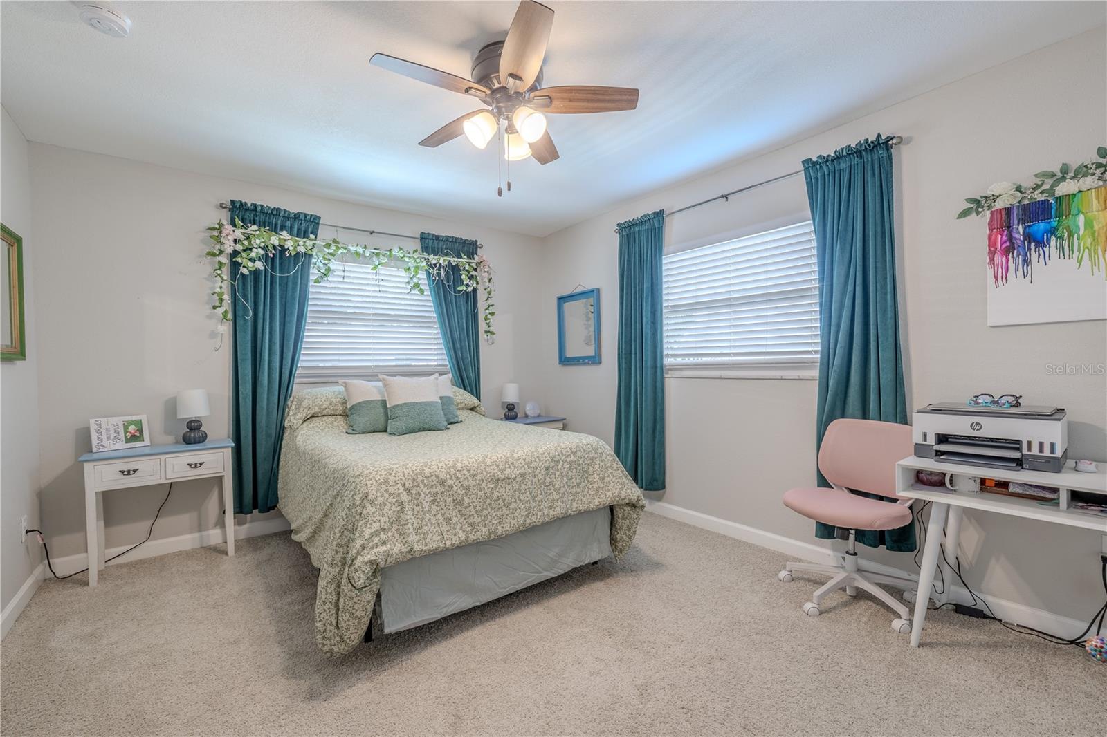 Bright and spacious primary suite offering a sense of tranquility at the back of the home. Large windows bring in filtered sunlight, creating a serene place to unwind.
