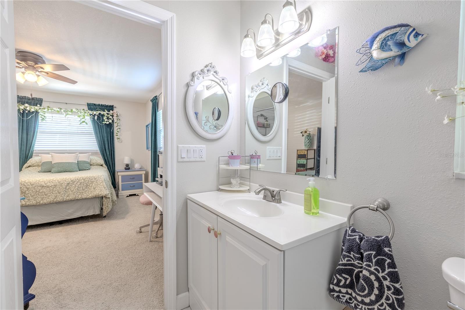 This view highlights the seamless connection between the bath and bedroom, showcasing a clean, coordinated design that feels both modern and timeless.