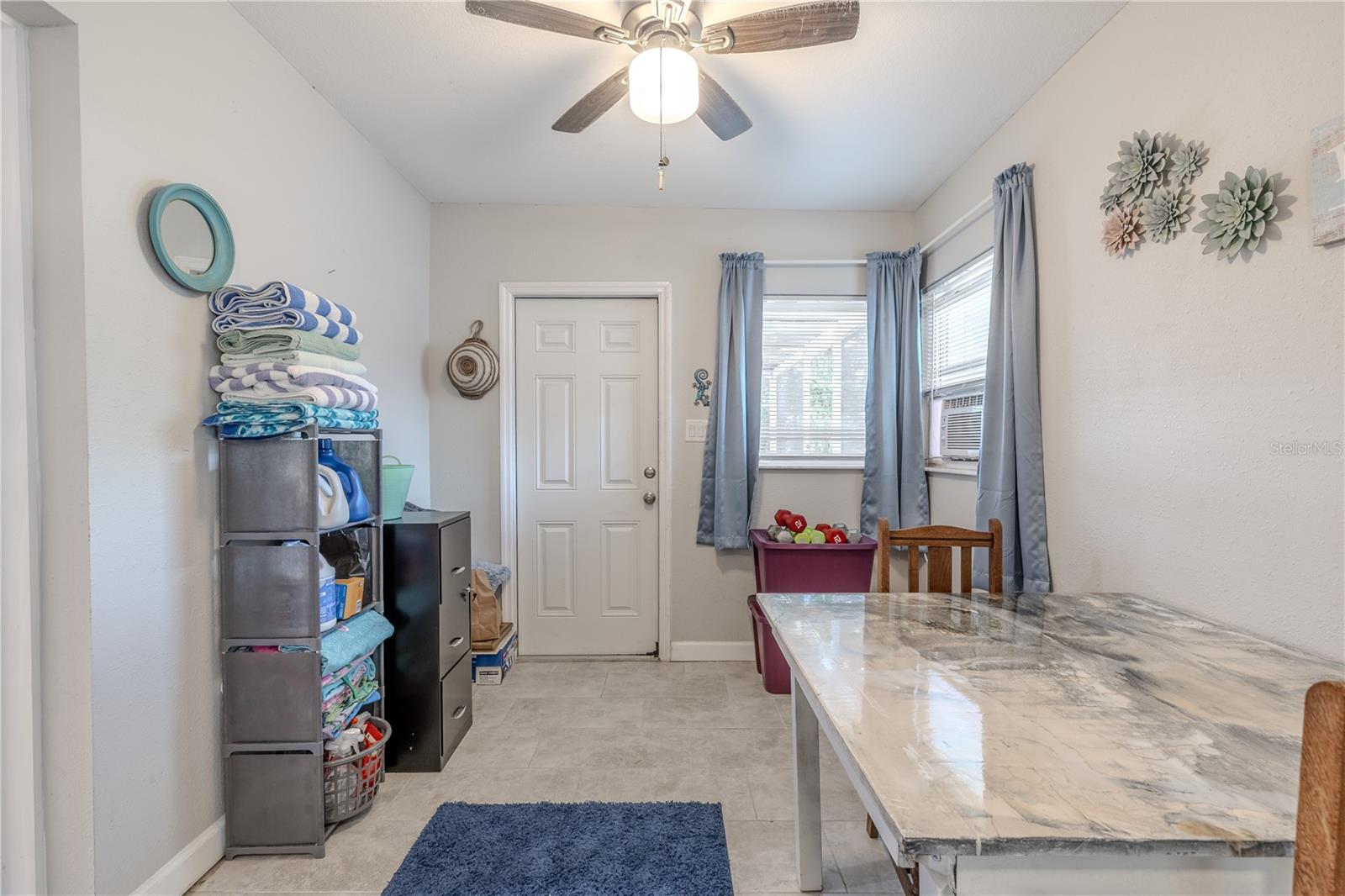 A bright, functional extension of the home that’s perfect for a laundry setup, craft space, or cozy lounge. Large windows keep the area feeling fresh and connected to the outdoors.