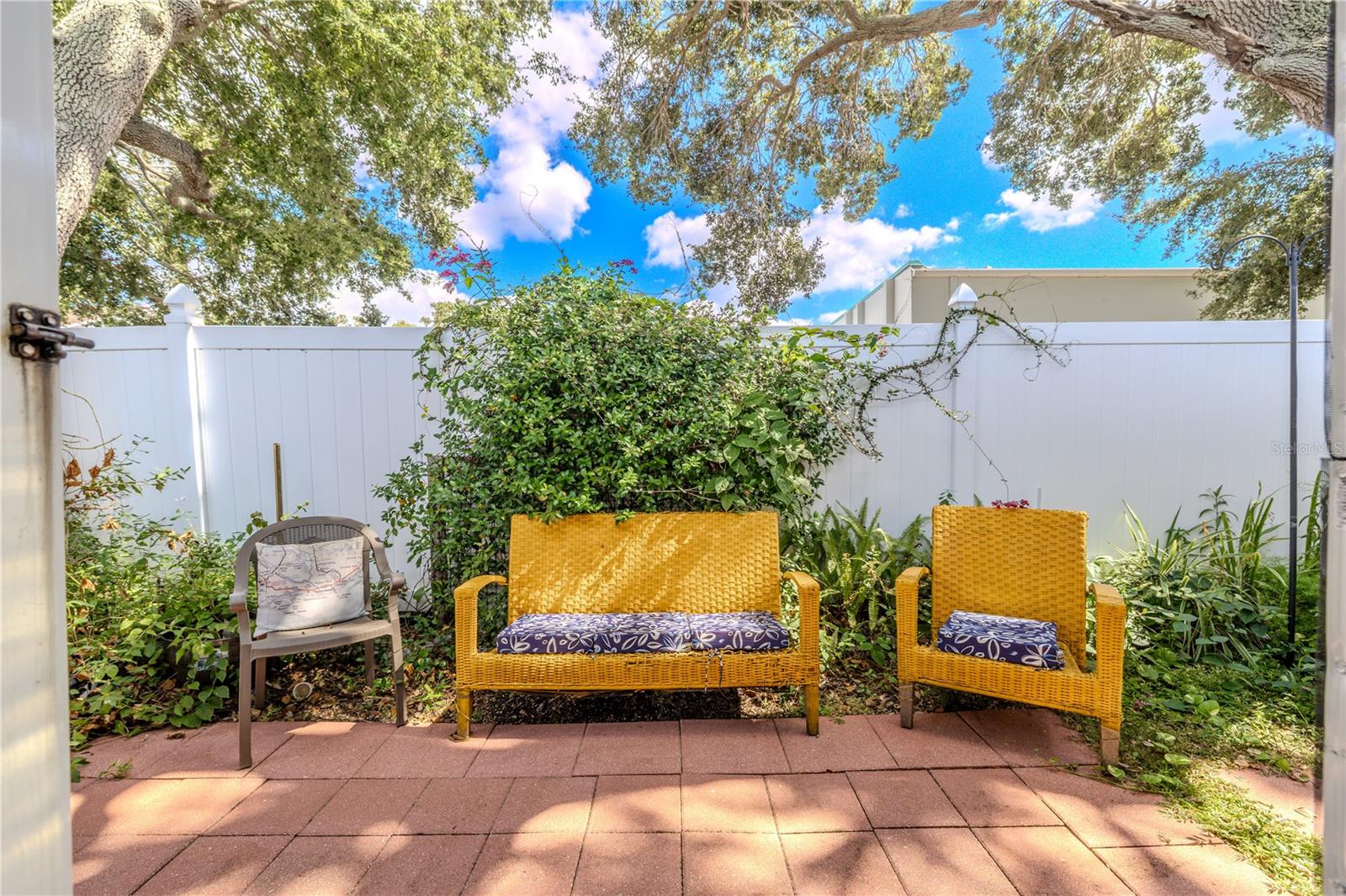 Step beyond the screen to the open patio area where the Florida sunshine takes center stage. Perfect for potted plants, a small dining set, or simply soaking in the calm surroundings.