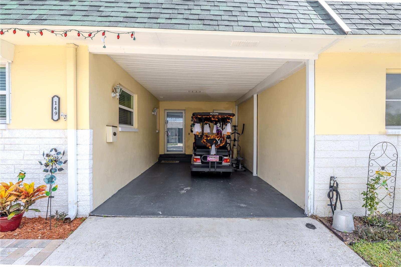 Convenient covered carport providing shade, easy entry to the home, and room for additional storage. The design emphasizes everyday comfort and accessibility.