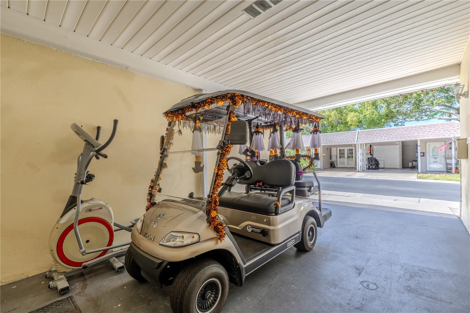 Spacious covered carport with additional storage and room for a golf cart, reflecting the community’s relaxed and golf-cart-friendly lifestyle.