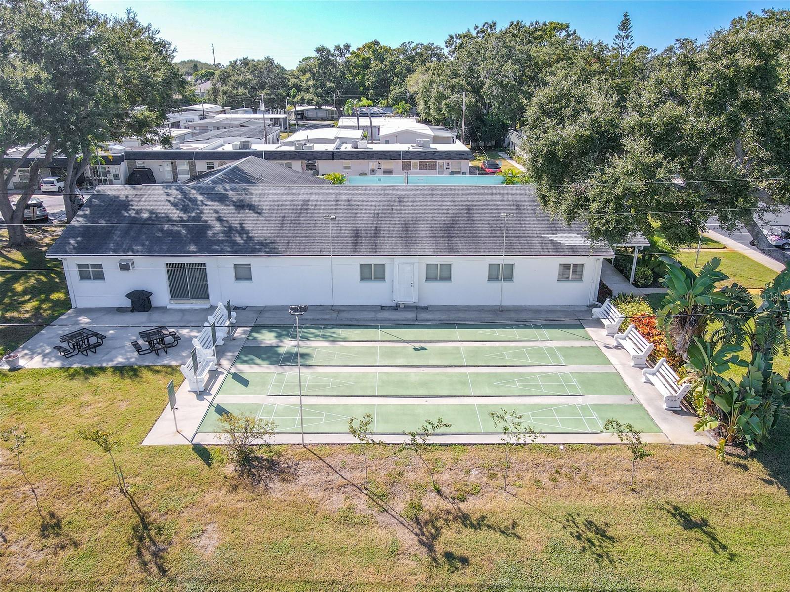 Well-maintained shuffleboard courts surrounded by greenery where neighbors gather for friendly games and afternoon fun. A true nod to the relaxed Florida lifestyle.