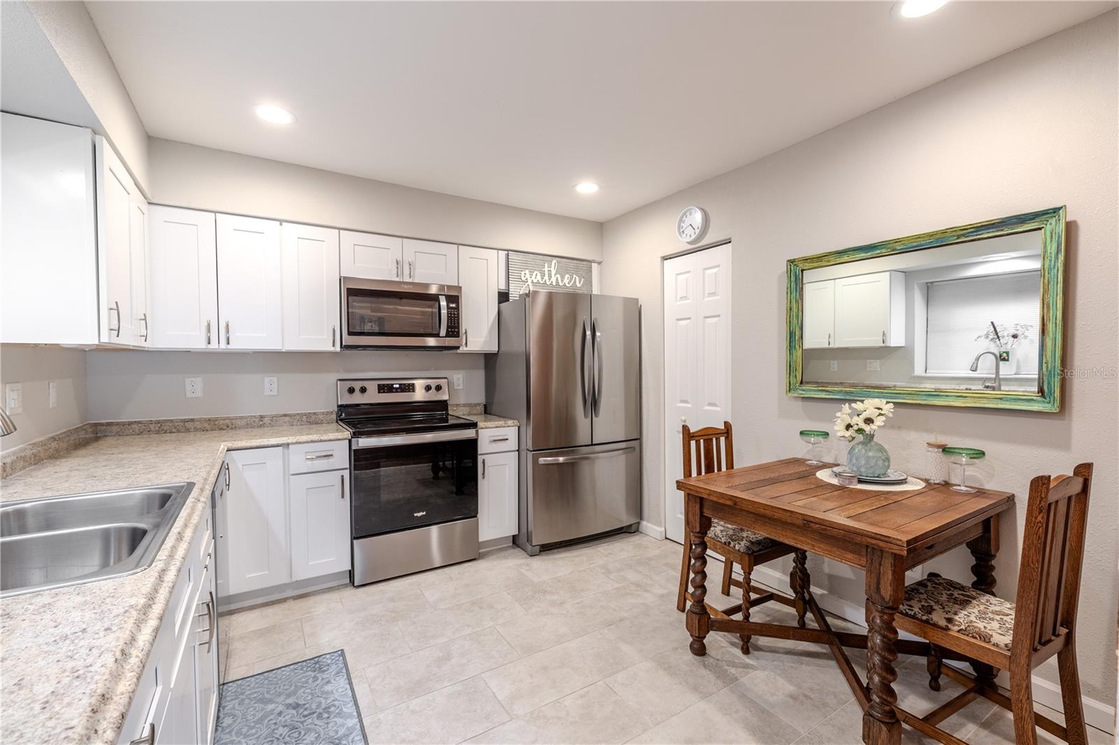 Beautifully maintained kitchen with ample cabinetry, generous counter space, and easy access to both the living and dining areas.