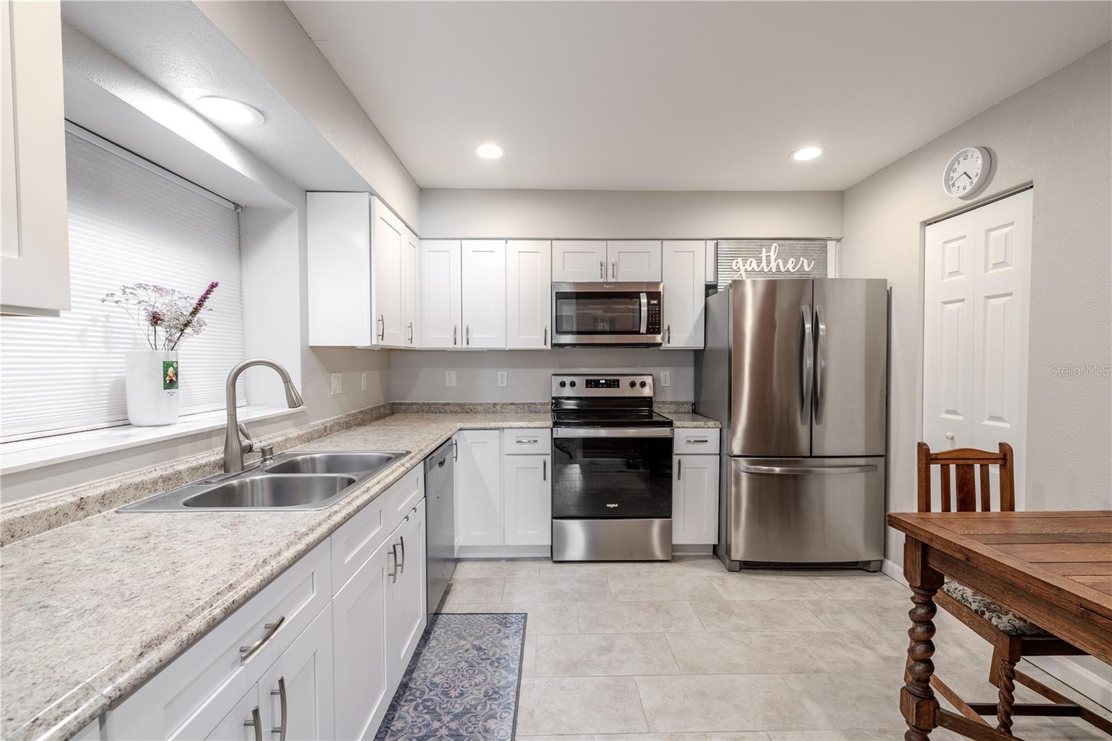 Modern neutral finishes including stainless steel appliances and a clean, functional design make this kitchen the perfect place for home cooking or entertaining guests.