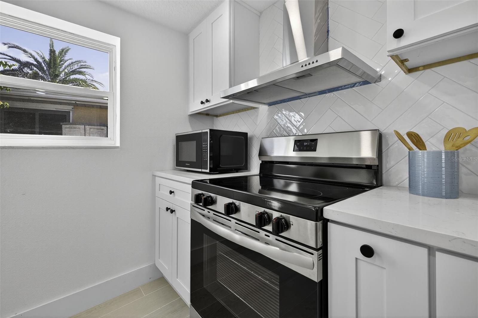 Kitchen includes Brand New Appliances including a new flat top stove & range hood