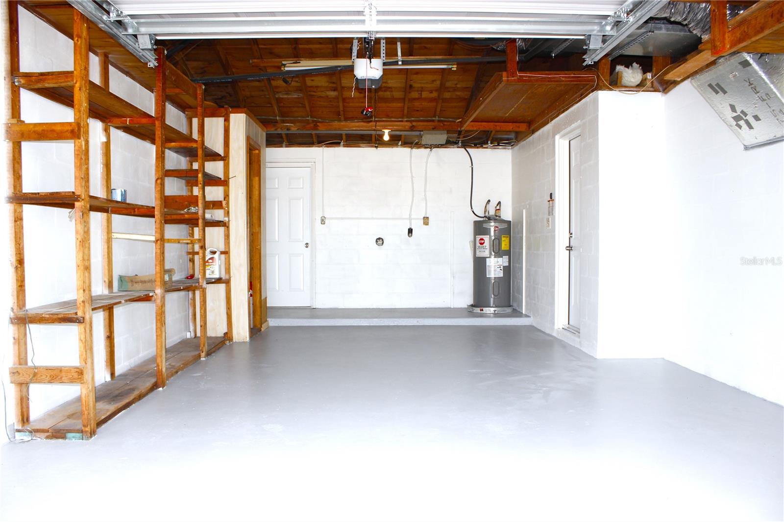 GARAGE WITH NEW GARAGE DOOR AOIBNTED FLOOR
