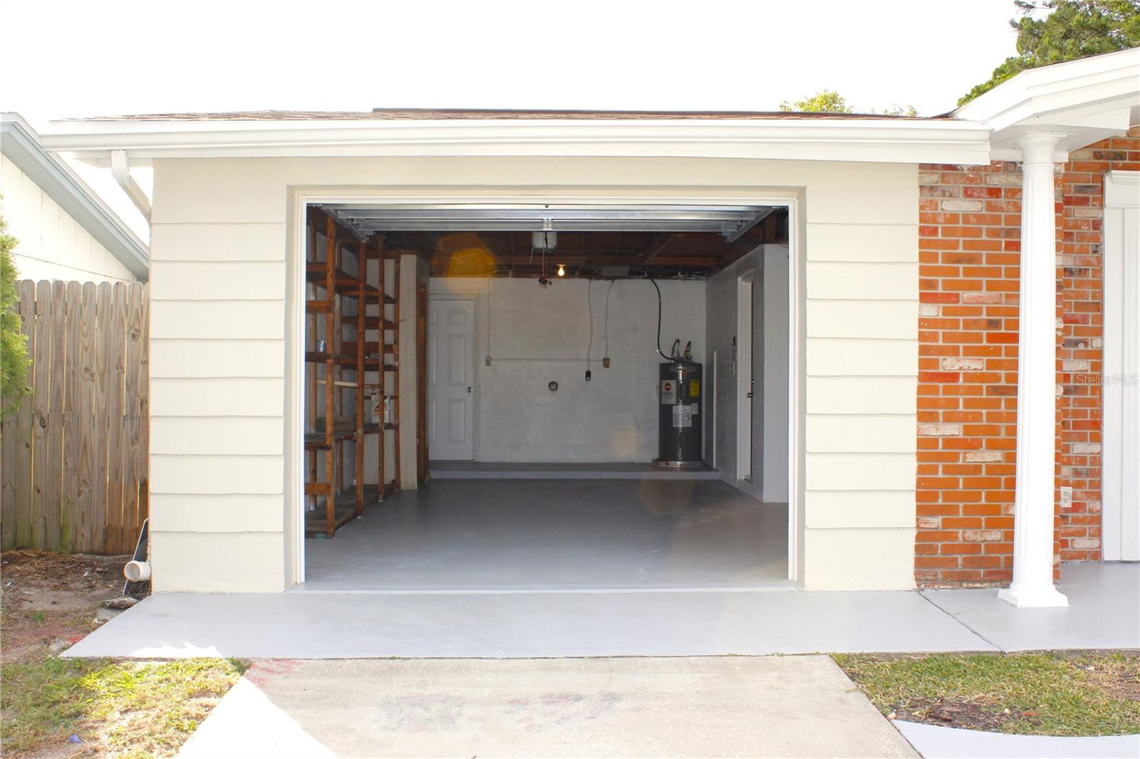 GARAGE WITH NEW GARAGE DOOR AOIBNTED FLOOR