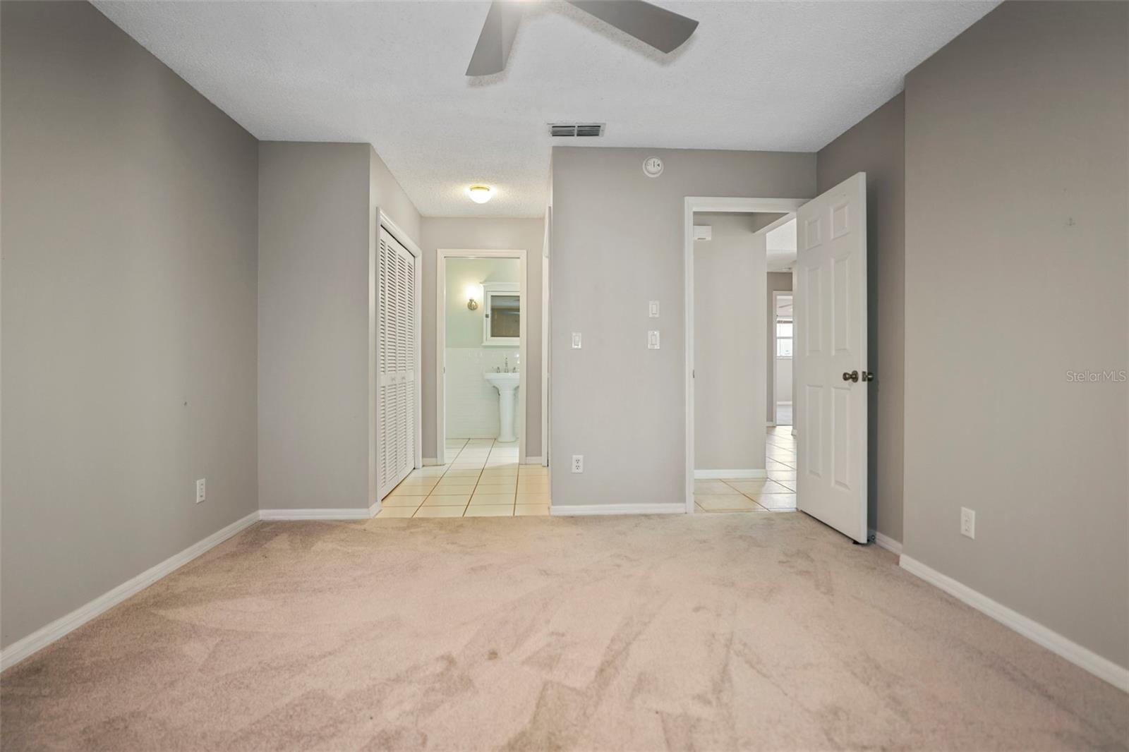 Primary bedroom with ensuite bathroom and closets