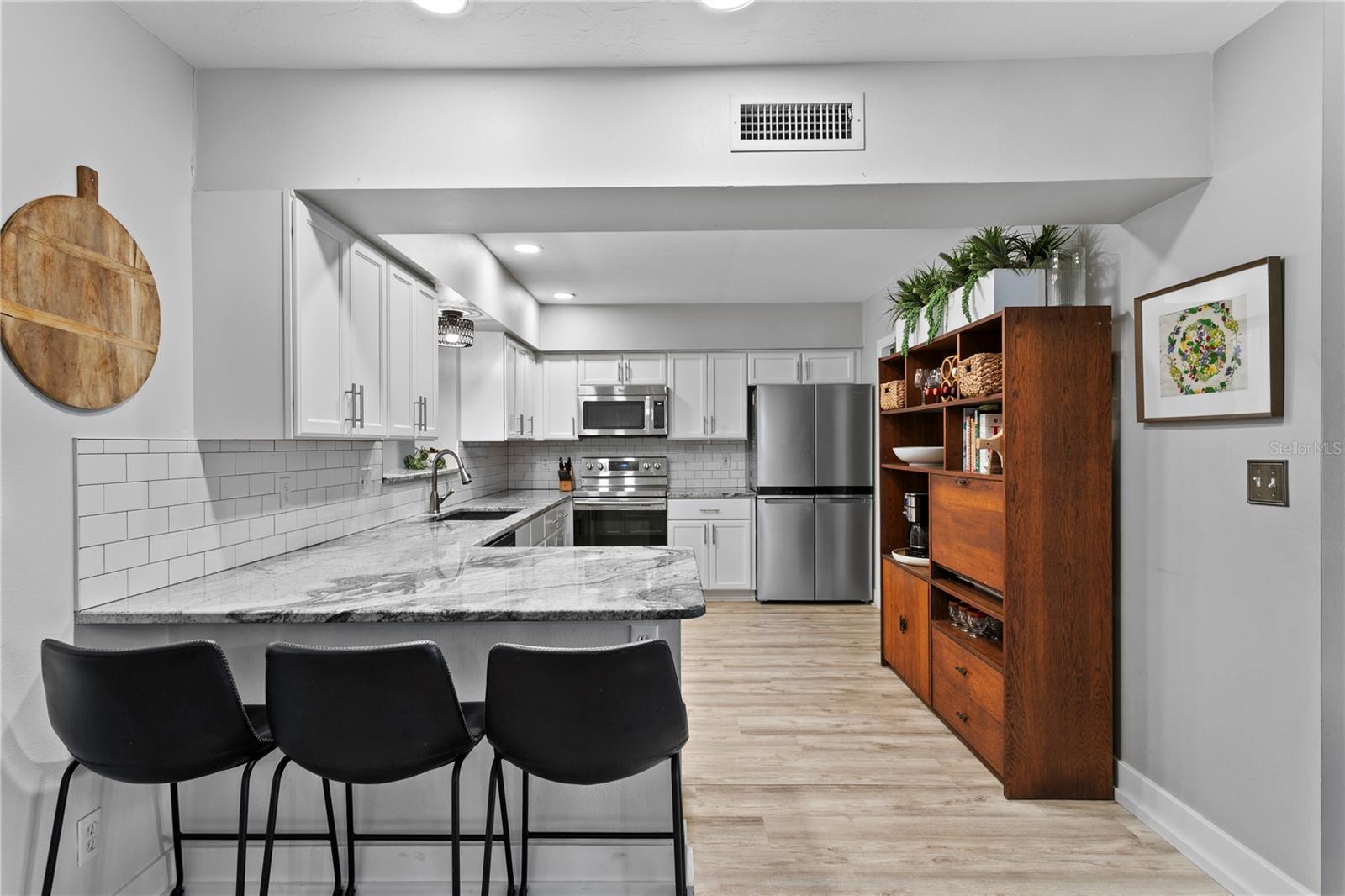 Enjoy a spacious kitchen with an eat-in area, abundant counter space, and plenty of room for cooking and/or gathering.