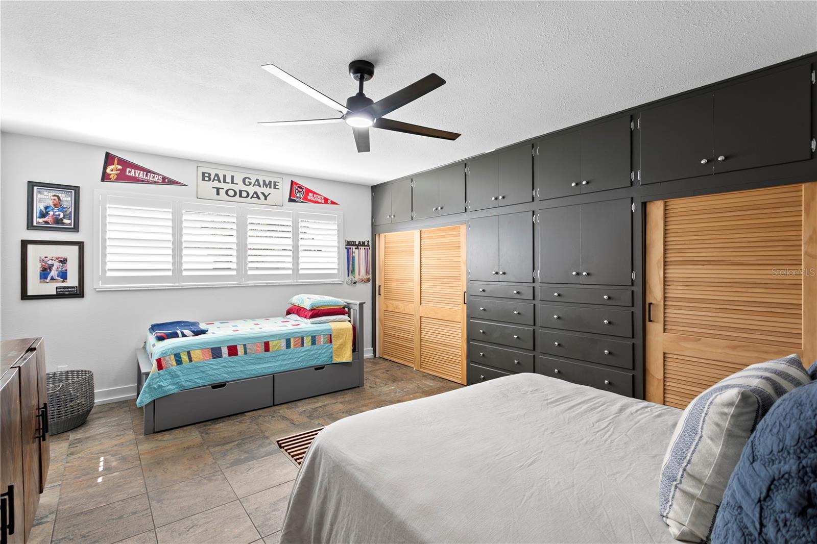 Bedroom Two is truly a second primary with an ensuite bathroom.  The custom closet doors and built-ins add a touch of design.