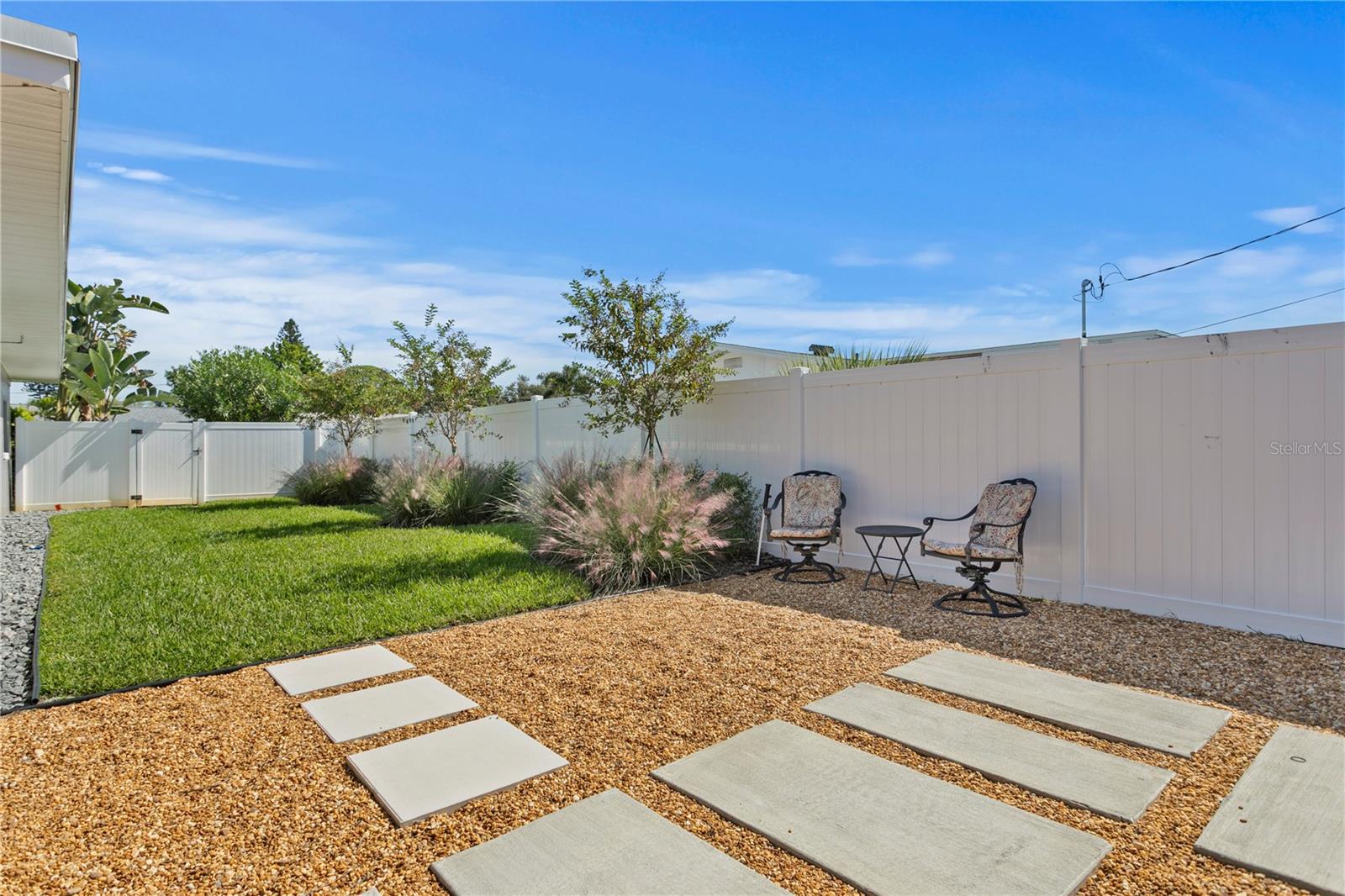 This dreamy backyard also has new cement walkway, new sprinkler system, and new landscaping.