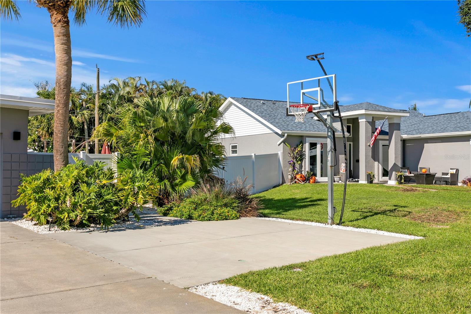 Sport Court with adjustable and lighted basketball hoop.