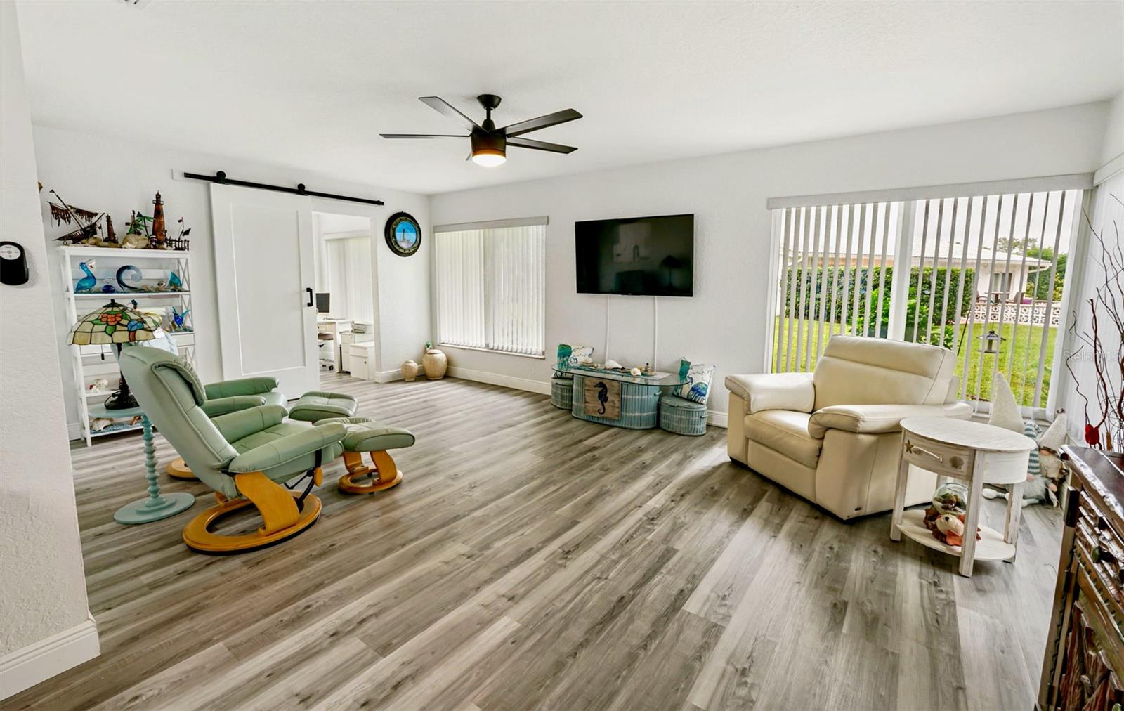 19-family room with barn door to bonus room