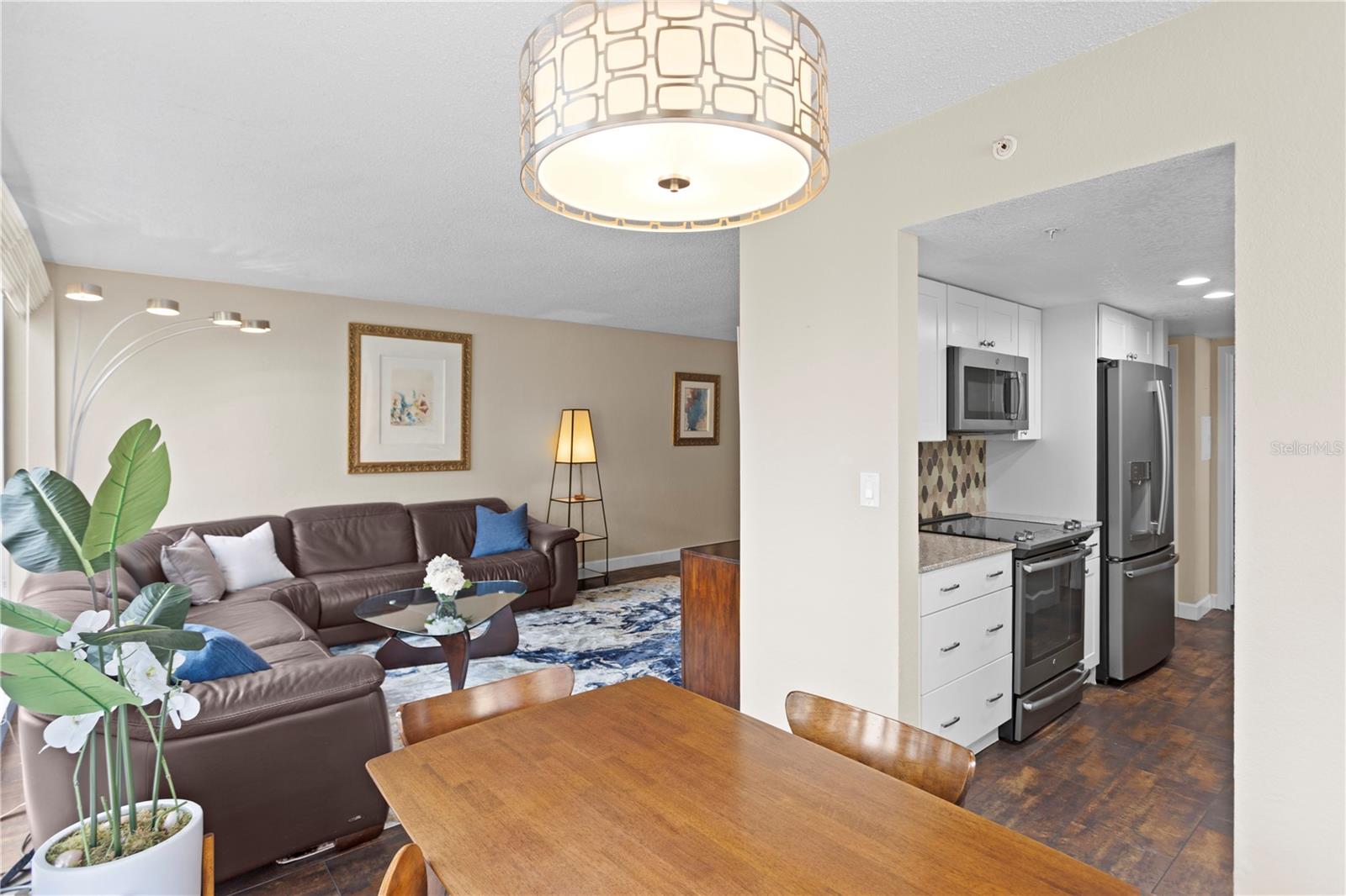 Standing in dining room and looking into living room and kitchen