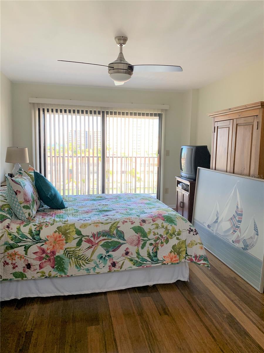 Master bedroom with views of water, access to patio