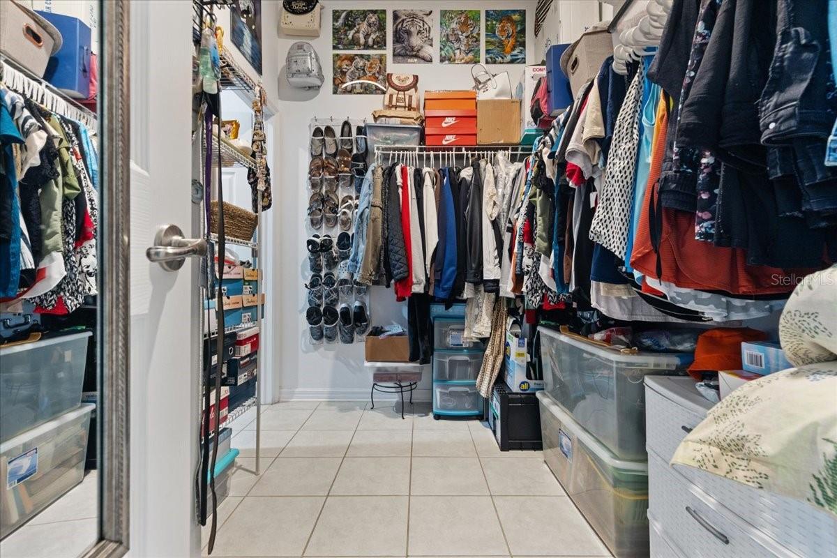 master closet with access to laundry room