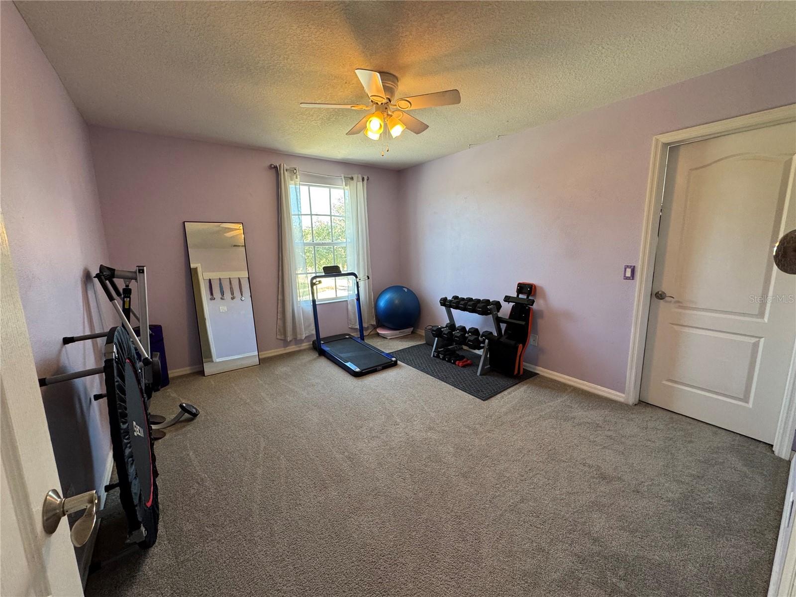 Secondary bedroom currently being used as a home fitness area