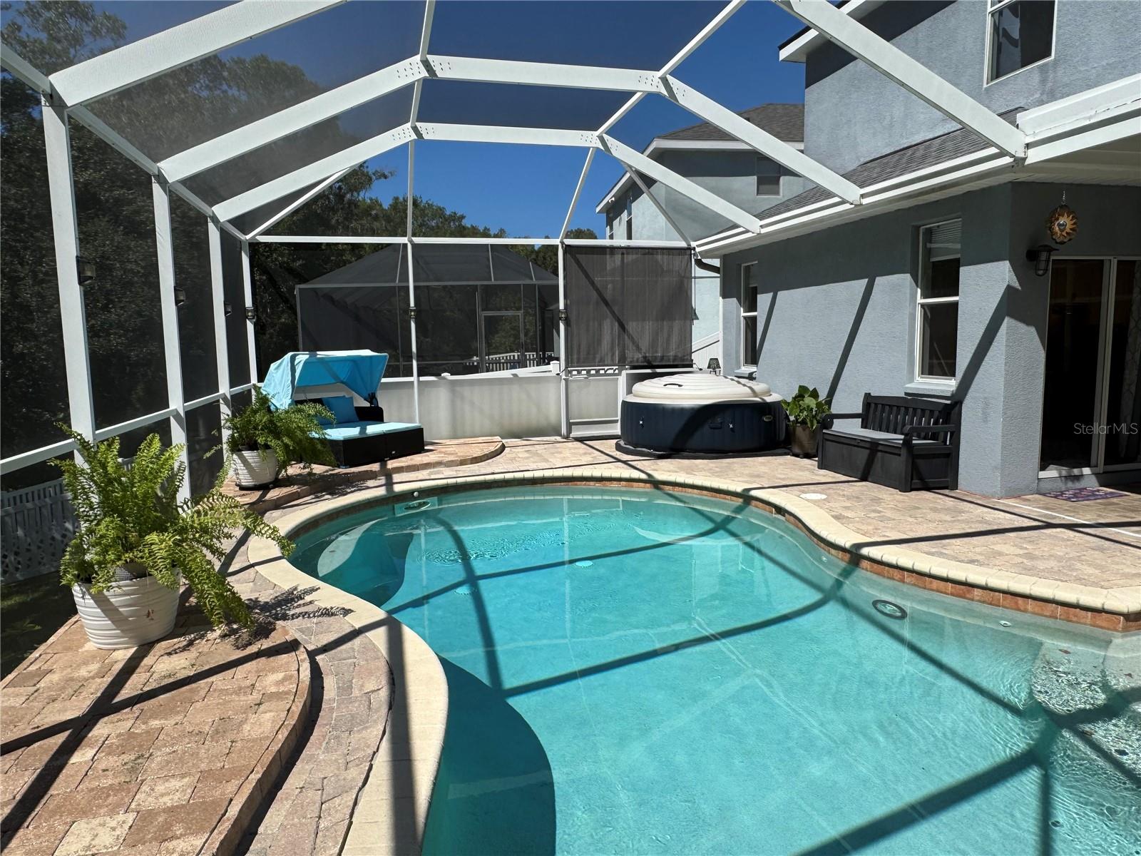 Fully screened pool with 6 person hot tub that stays with the home.