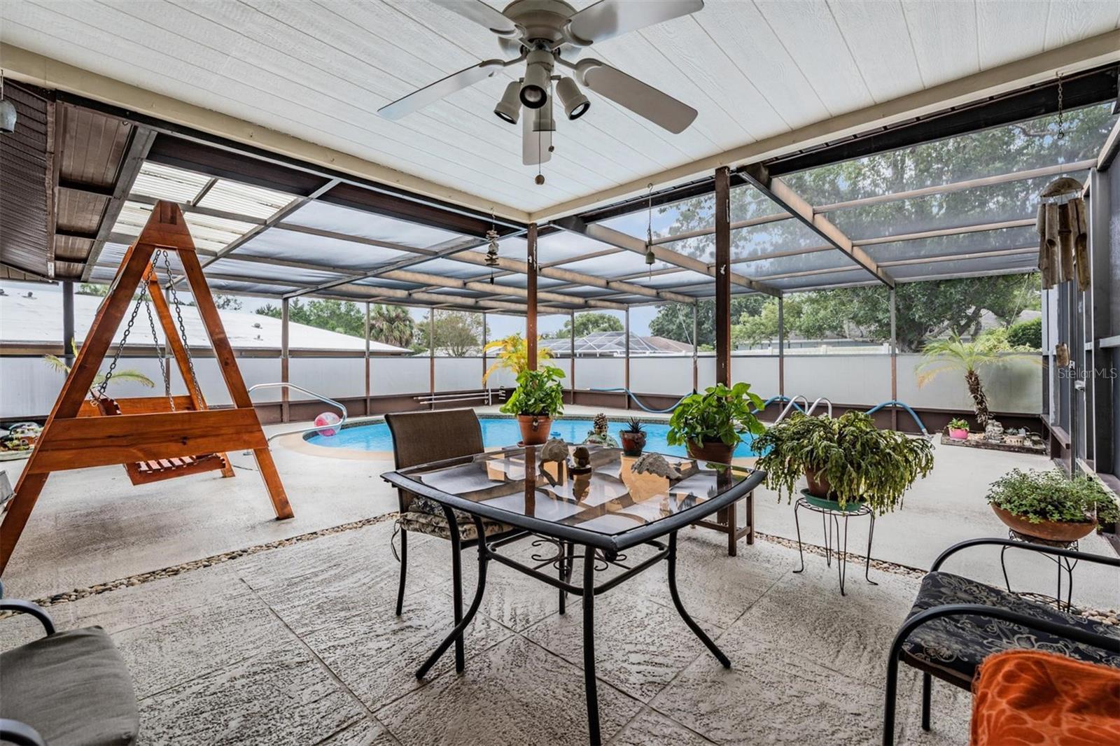 Covered area for pool area with fan and light kit. Swing does not convey