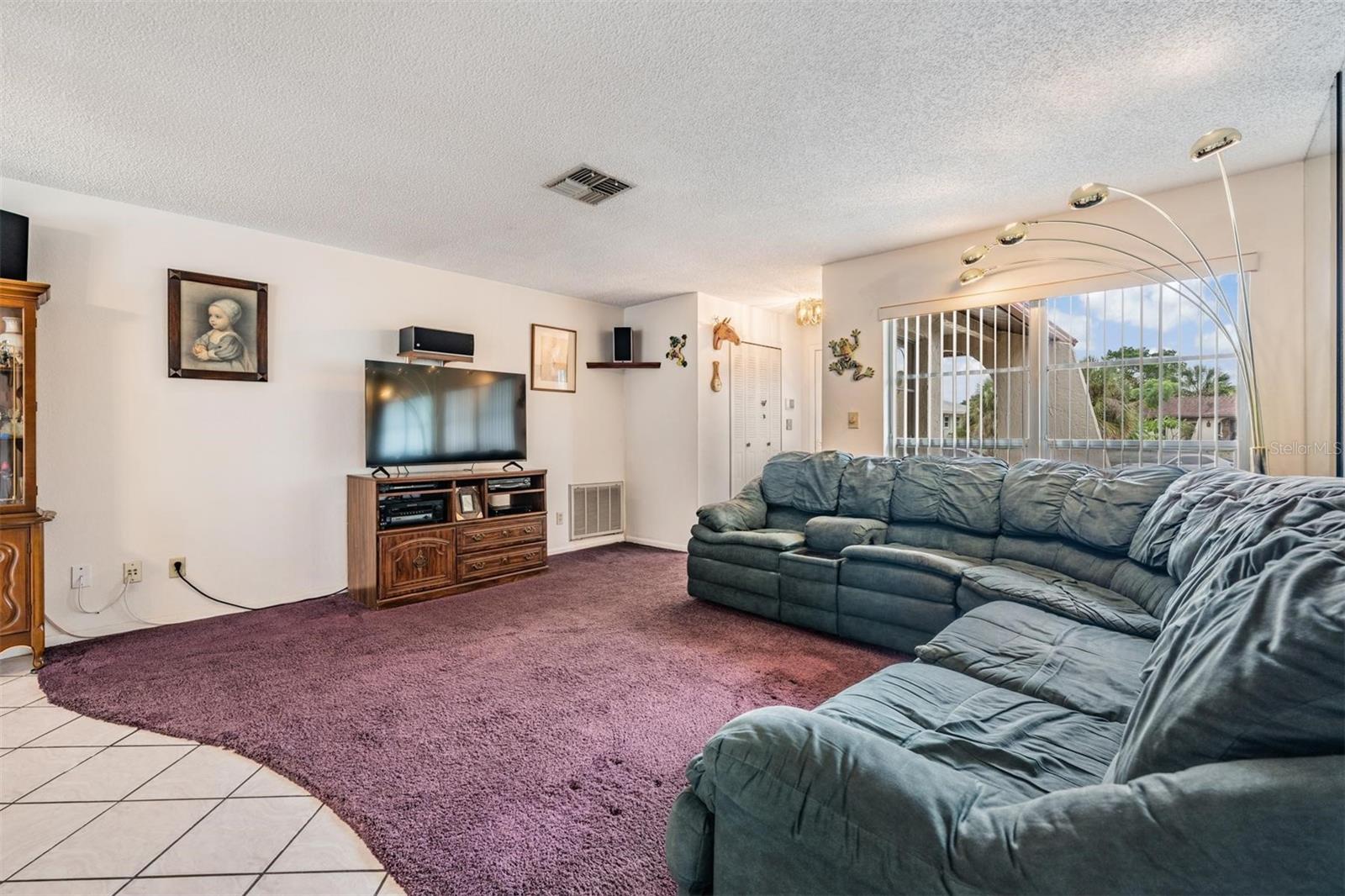 Front door has double closet  doors with a bright window in  foyer.