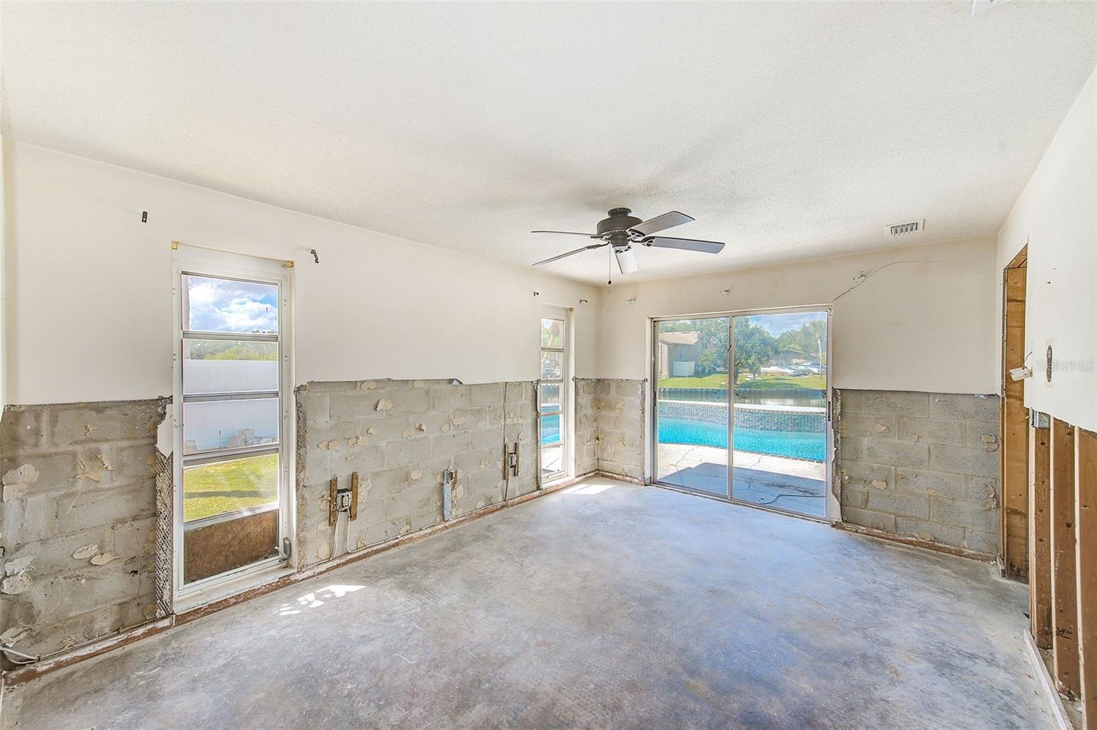 Primary bedroom with sliders to pool and backyard
