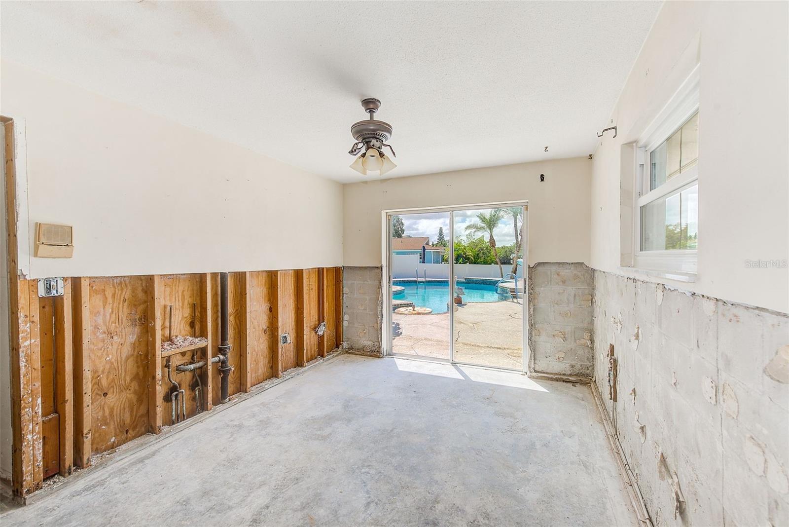 Bedroom 4 with a view and sliders to pool and waterfront