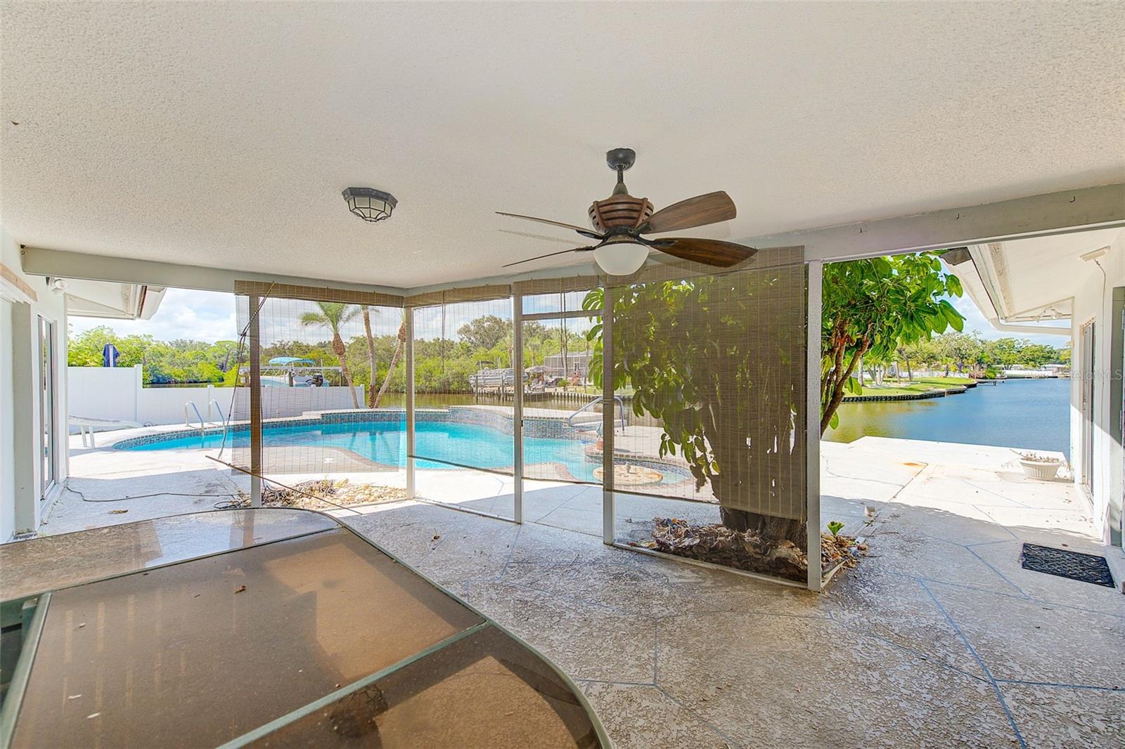 Covered lanai overlooking pool and waterfront