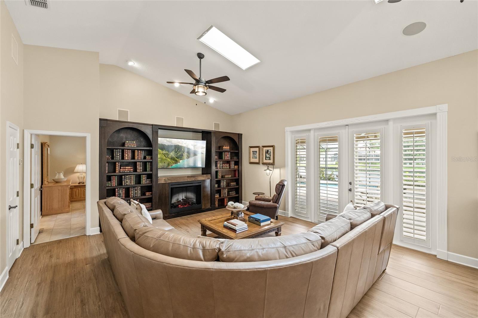 Stunning, classic bookshelves surround an electric fireplace creating a cozy and intimate gathering space.