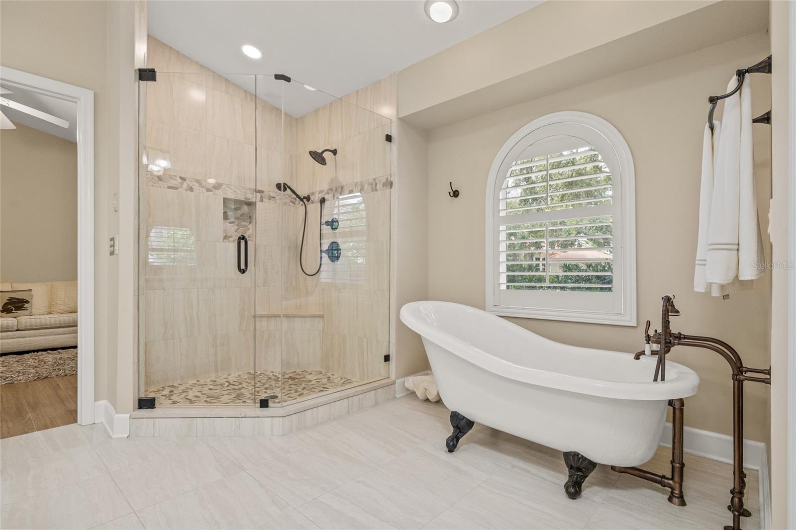 Primary bathroom was fully remodeled with a stunning step in shower, claw foot tub and two independent vanity sink areas.