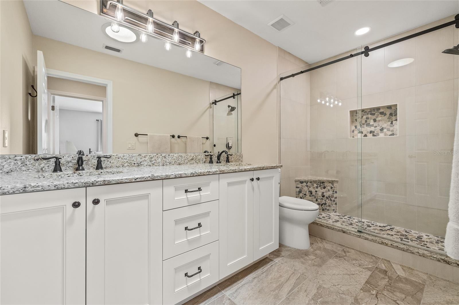 Fully remodeled bathroom in between bedrooms 3 and 4.