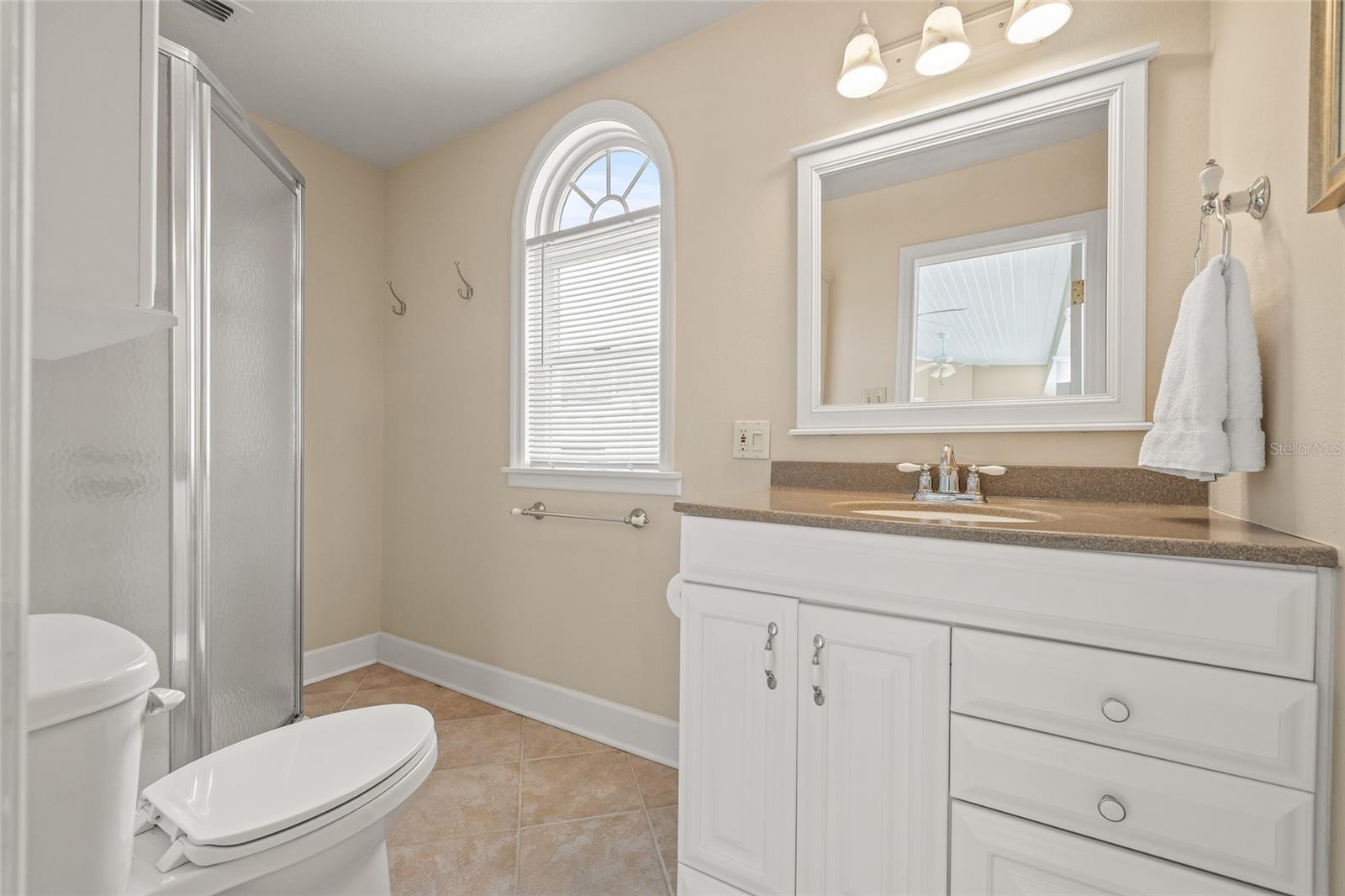 Full pool bathroom with a shower is accessed outside by the pool.