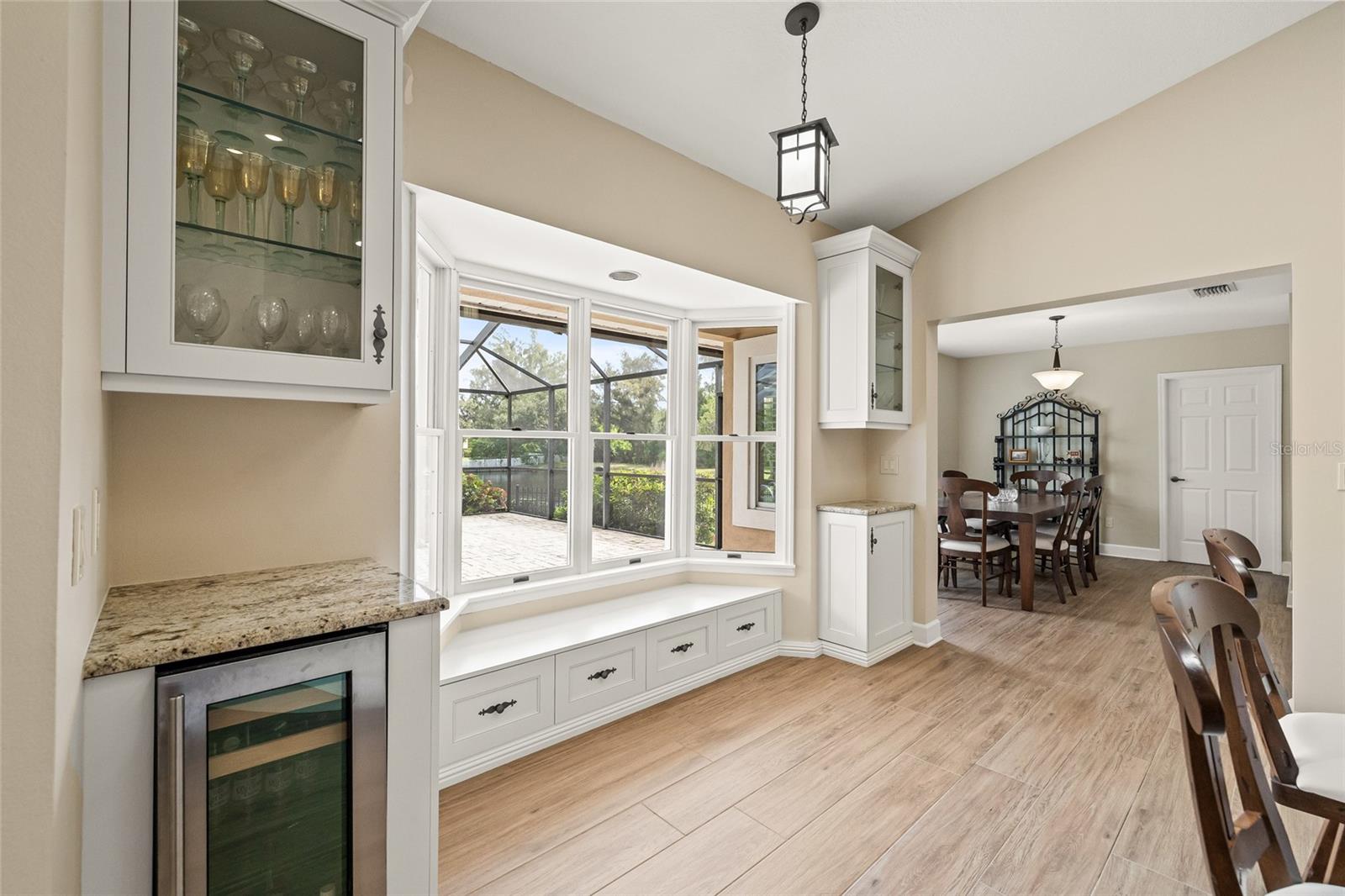 Built in dry bar with custom display shelves for beverage glasses, ceramics and platters.